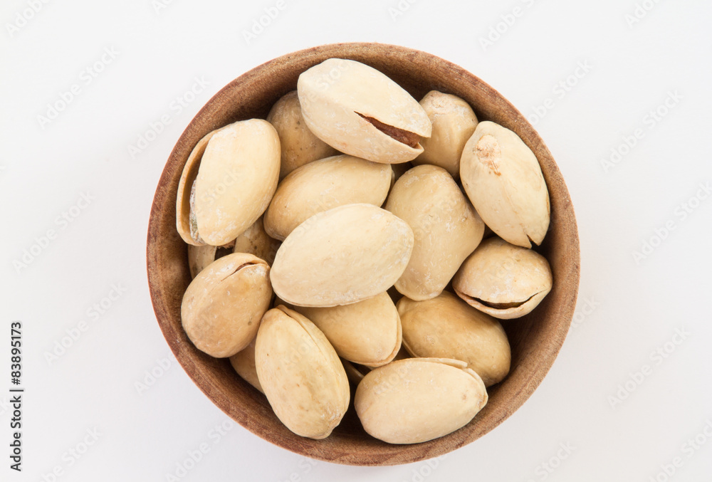 Pistachios in a round wooden form Pistachios in a round wooden form