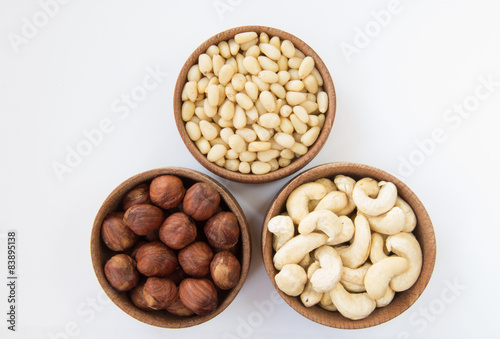 Three types of nuts in a round wooden form