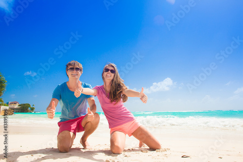 back view of happy young couple on the beach