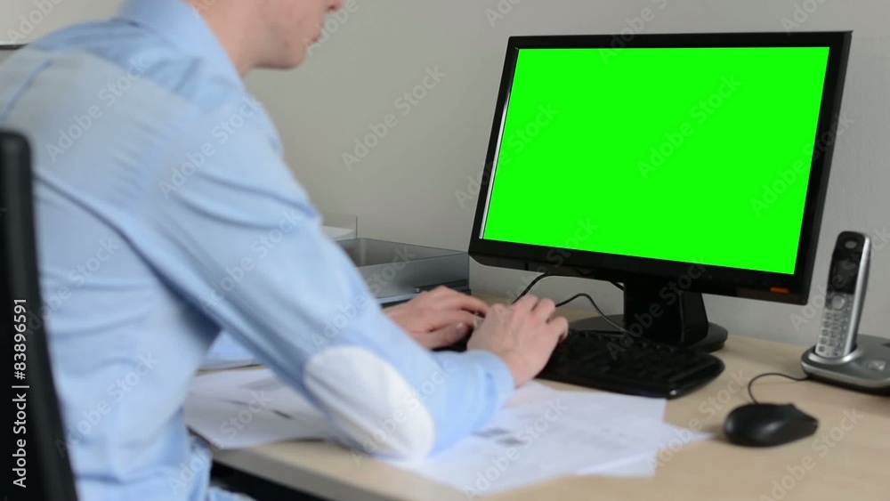 man works on desktop computer in the office - typing on keyboard - green screen man works on desktop computer in the office - typing on keyboard - green screen