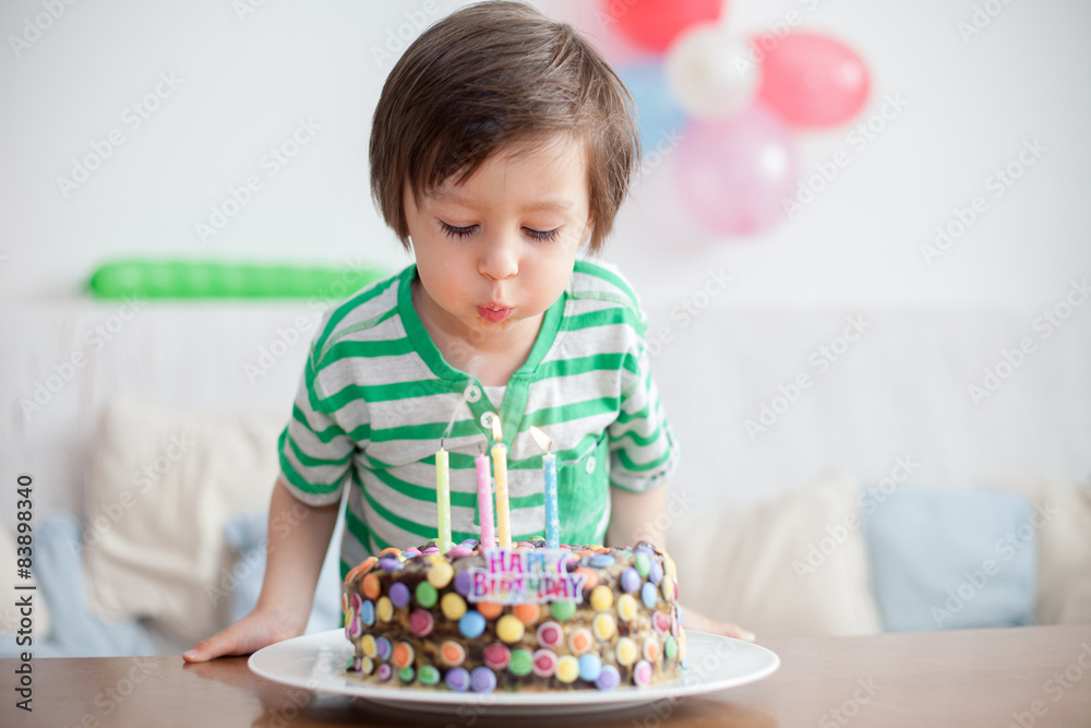 Beautiful adorable four year old boy in green shirt, celebrating Beautiful adorable four year old boy in green shirt, celebrating