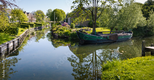 Old barge in the canal of a village