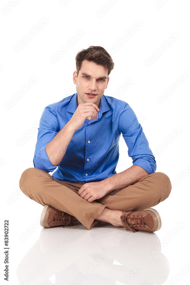 Handsome young fashion man sitting with his legs crossed. Handsome young fashion man sitting with his legs crossed.