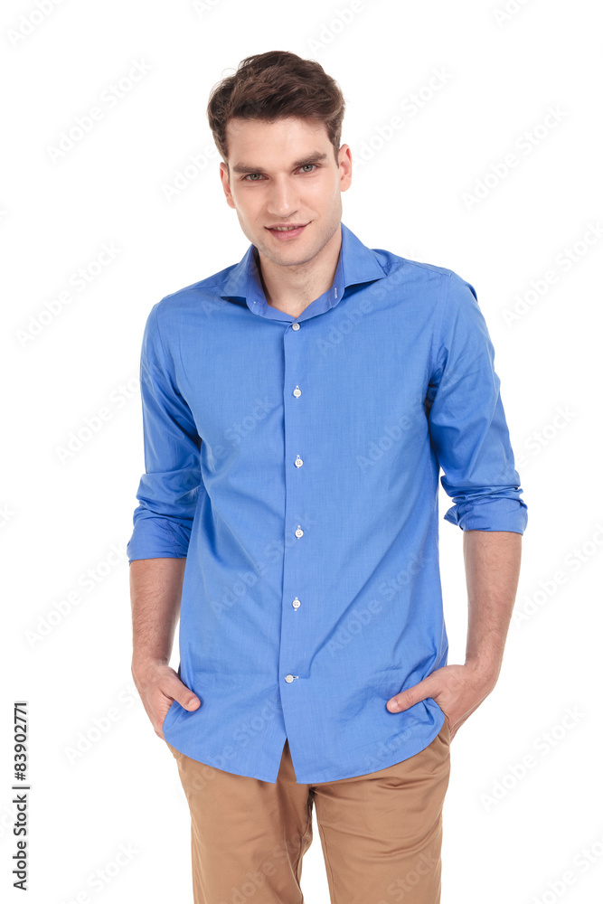 Smiling man holding his hands in pockets Smiling man holding his hands in pockets