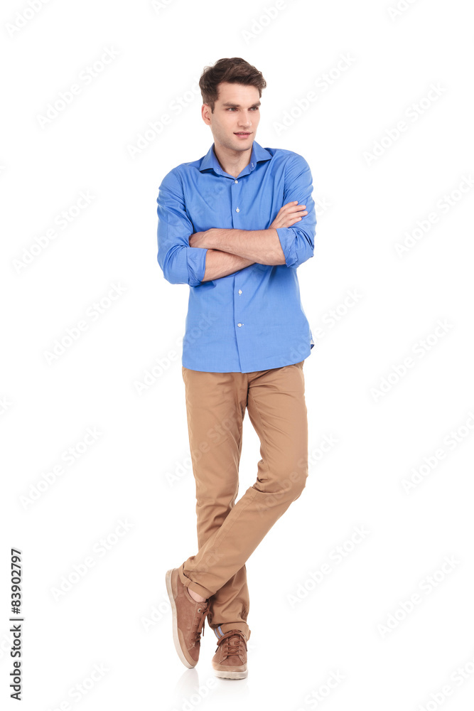 young man standing with his hands crossed young man standing with his hands crossed