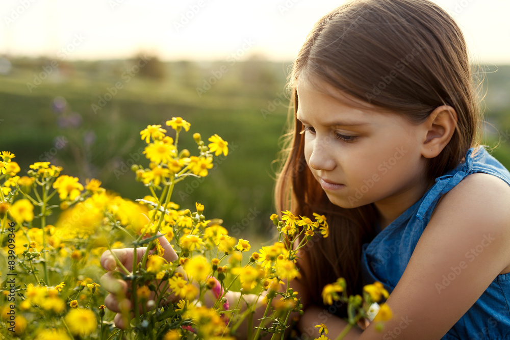 little girl smelling a yellow flower little girl smelling a yellow flower