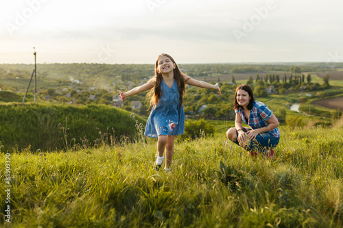 Little girl running on meadow