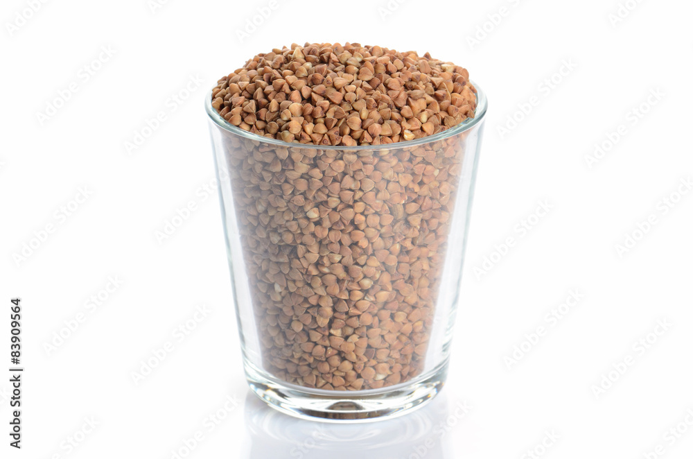 heap of buckwheat and glass isolated on white heap of buckwheat and glass isolated on white