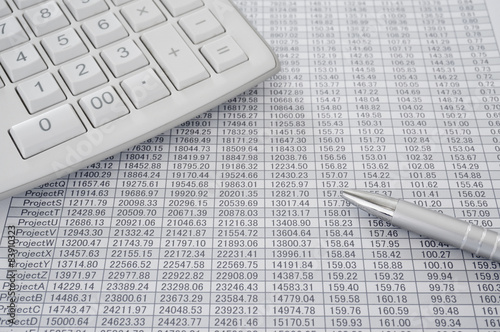 Calculator and pen on spreadsheet