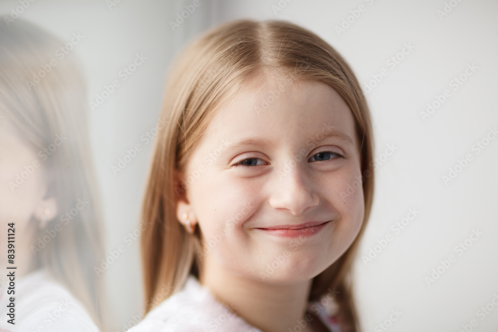 Little girl sitting on the windowsill Little girl sitting on the windowsill