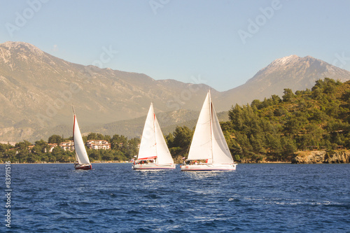 Three boats on the background of the high mountains