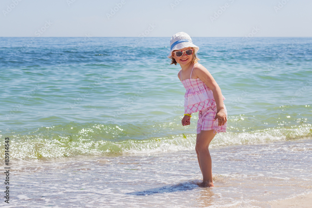 Little girl running and playing on the beach. Little girl running and playing on the beach.