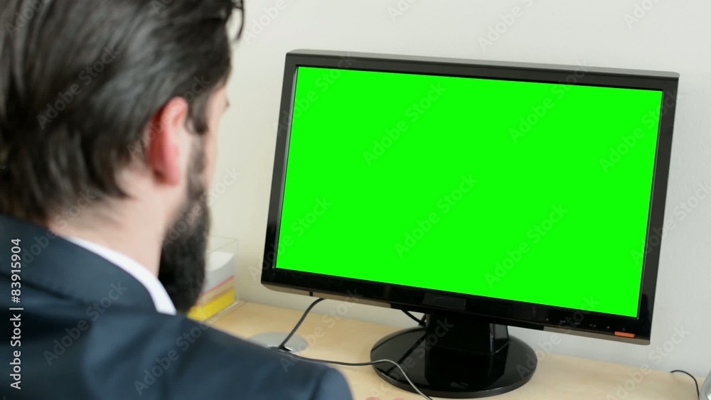 young handsome man with full-beard (hipster) works on desktop computer in the office - closeup young handsome man with full-beard (hipster) works on desktop computer in the office - closeup