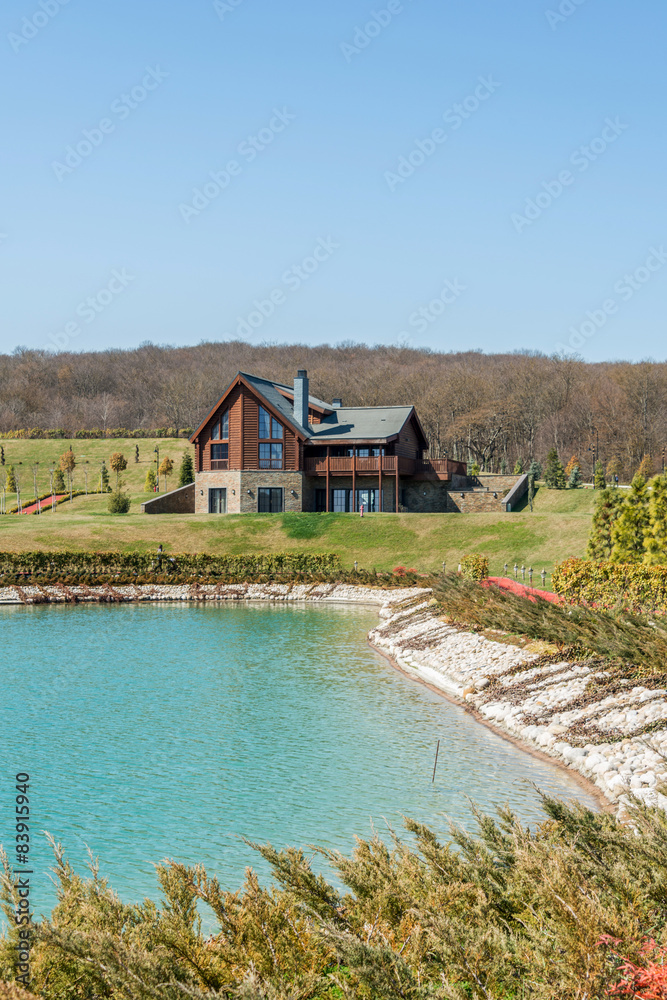 Modern house near water on bright day Modern house near water on bright day