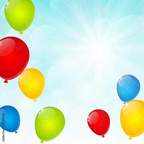 Color glossy balloons on sunny background 