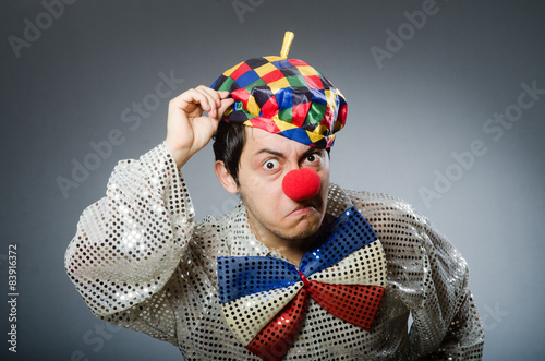 Funny clown against dark background