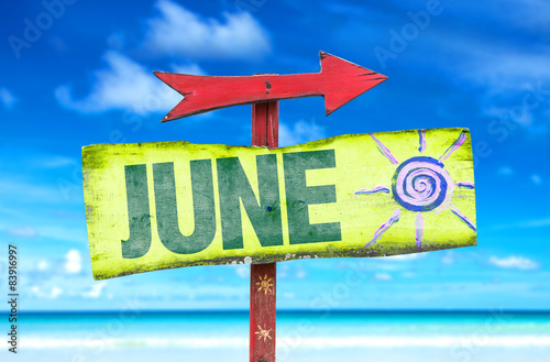 June direction sign with beach background