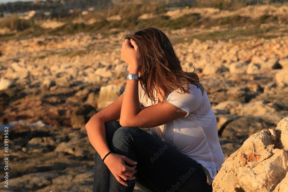 Thinking young (25-30) Sicilian girl near the beach at sunset. Thinking young (25-30) Sicilian girl near the beach at sunset.
