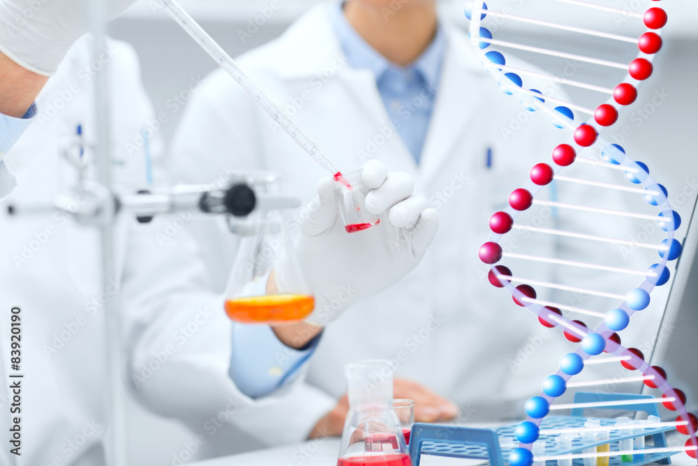 Fototapeta premium close up of scientists filling test tube in lab