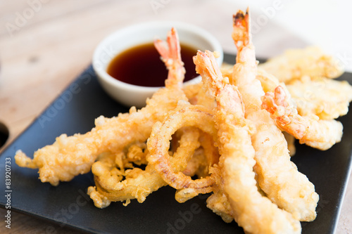 close up of deep-fried shrimps and soy sauce