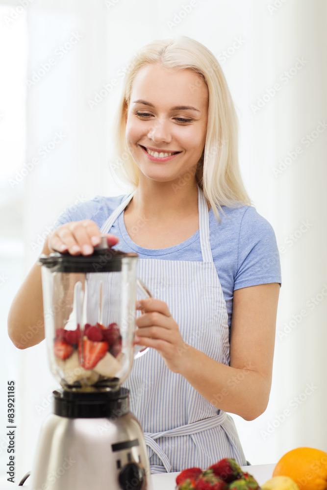 smiling woman with blender preparing shake at home smiling woman with blender preparing shake at home