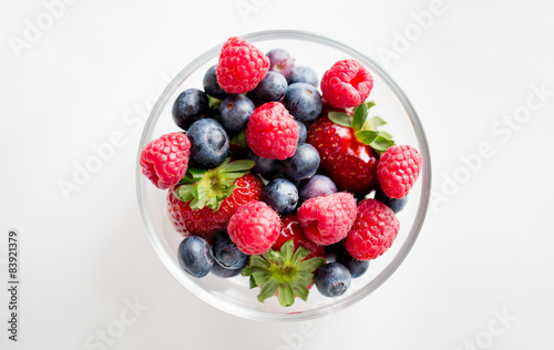 close up of summer berries in glass bowl