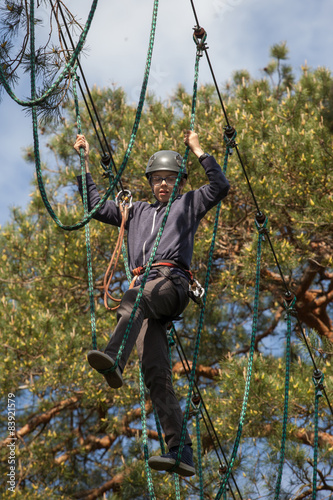 boy climbing in adventure park, rope park 