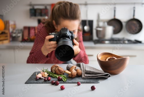 Woman food photographer taking closeup of mushrooms