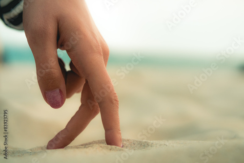 Wallpaper Mural Women's Fingers are walking on the sand at the beach Torontodigital.ca
