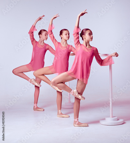 Ballerinas stretching on the bar photo