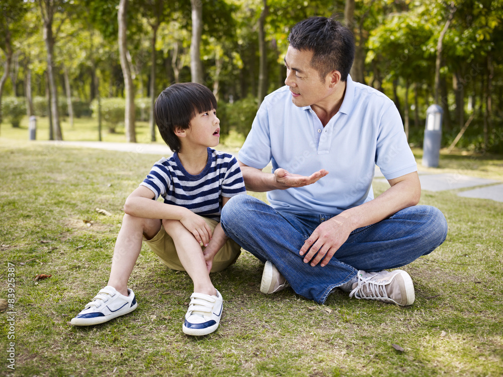 asian father and son having a conversation asian father and son having a conversation