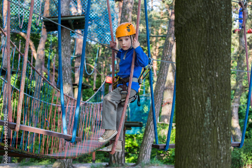 boy climbing in adventure park, rope park