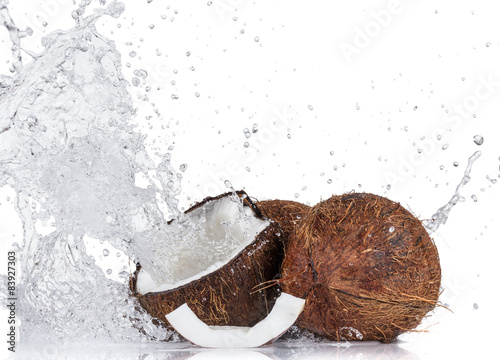 Cracked coconuts on white background © Lukas Gojda