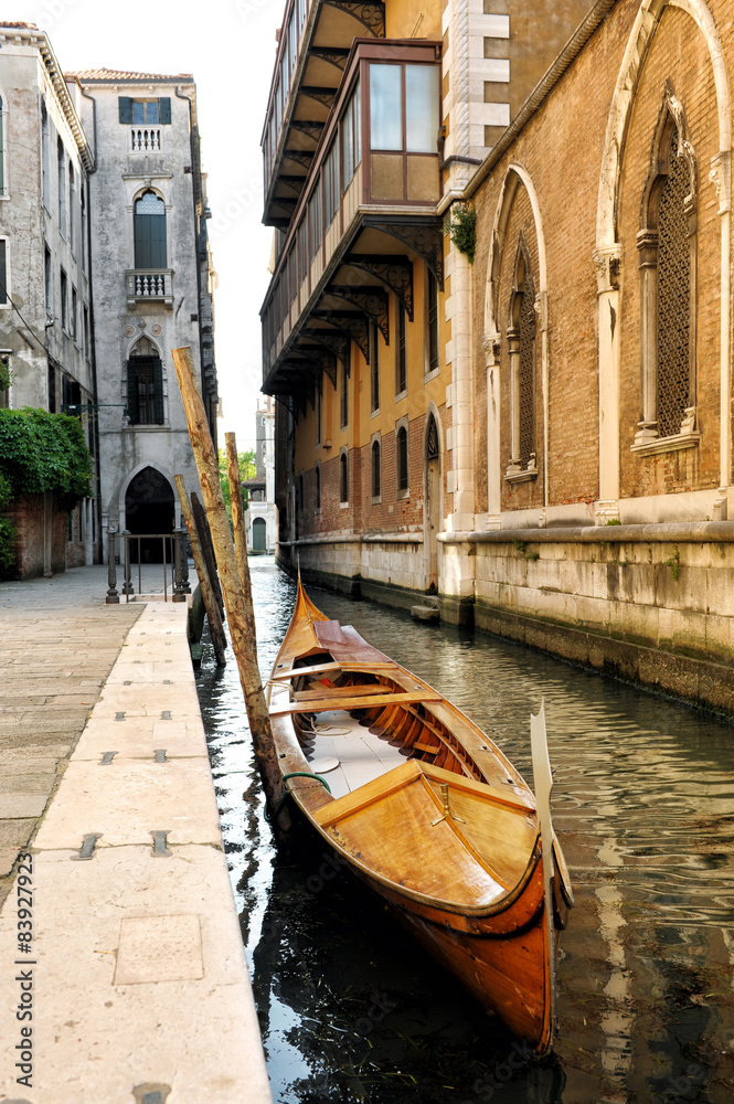 Wooden Gondola in Narrow Venetian Canal, Italy