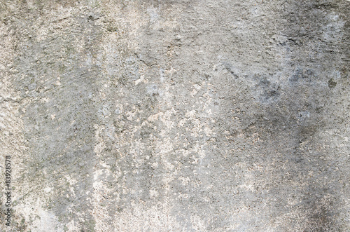 Gray cement wall with traces of the brush on the crumbling plast