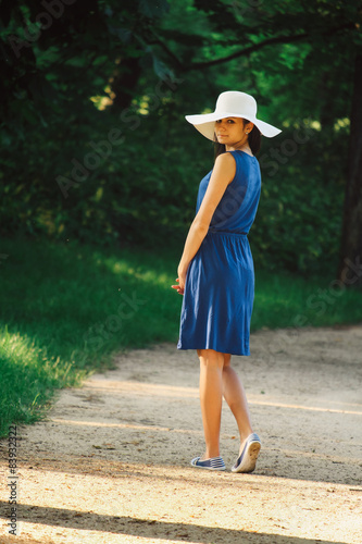 Attractive young adult woman in outdoor blue dress © Creaturart