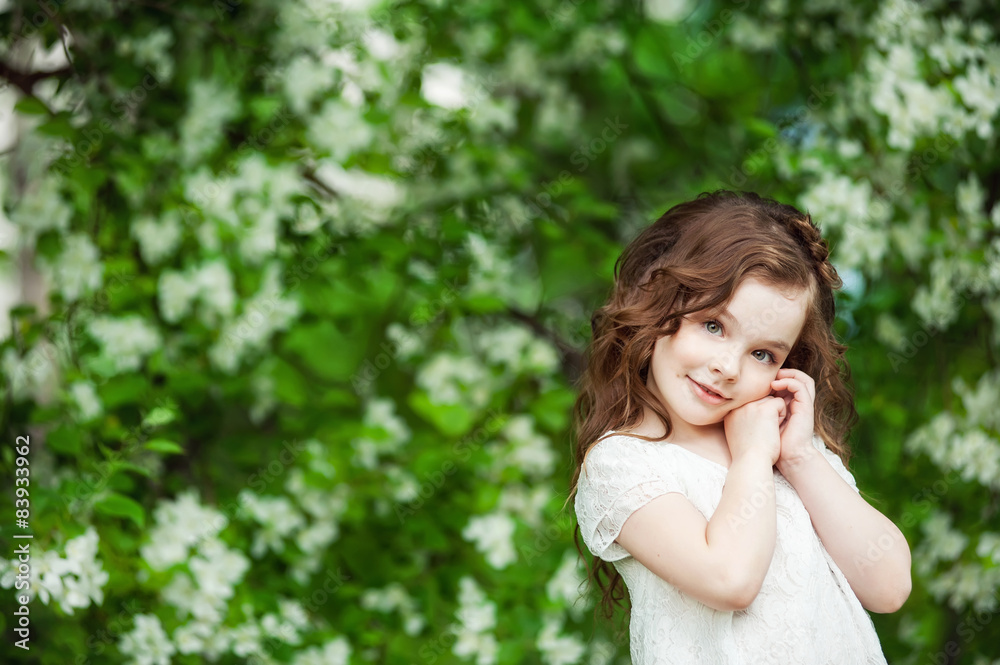 Portrait beautiful little girl near blossoming apple-tree Portrait beautiful little girl near blossoming apple-tree