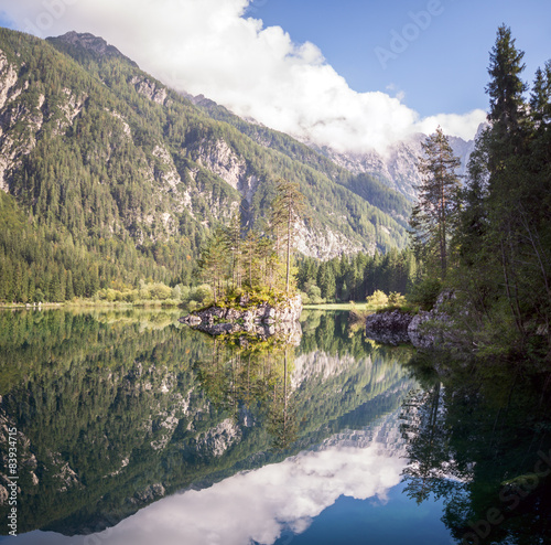 Rock island on mountain lake photo