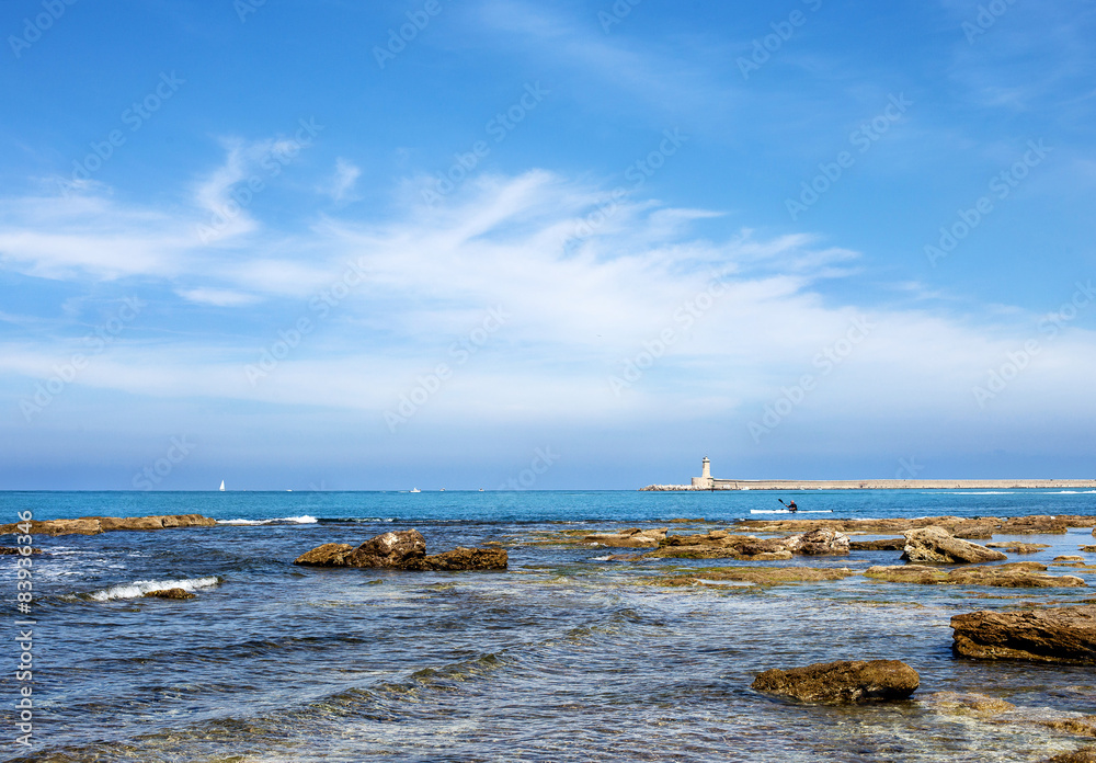 Seascape of Livorno coast with dam and lighthouse in the backgro