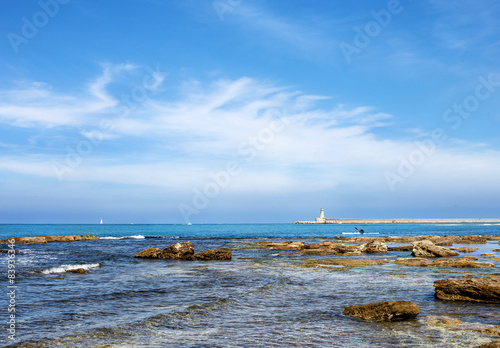 Seascape of Livorno coast with dam and lighthouse in the backgro