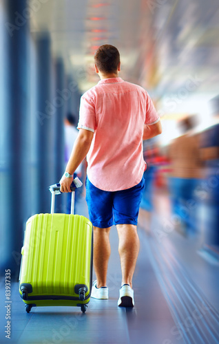 young man runs, hurry in order not to miss the plane photo