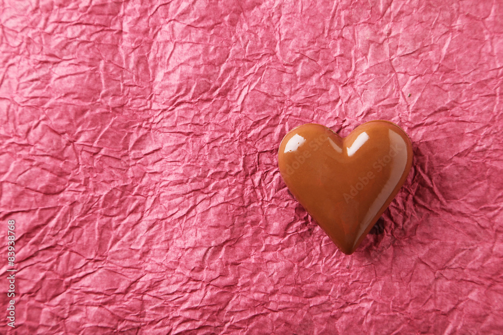 Chocolate heart on paper background Chocolate heart on paper background