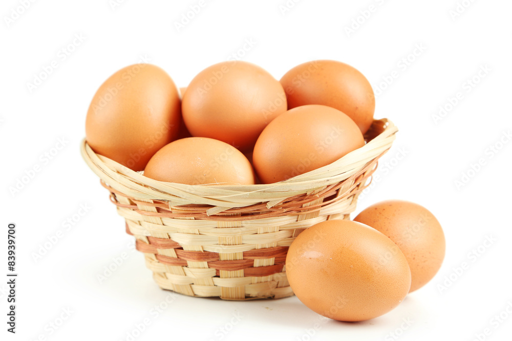 Chicken eggs in basket isolated on white