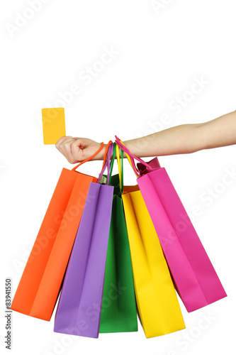 Female hand holding colorful shopping bags