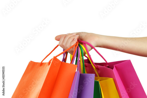 Female hand holding colorful shopping bags
