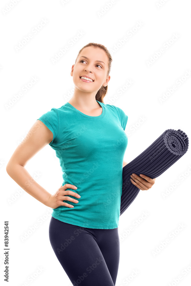 Young girl holding an exercise mat Young girl holding an exercise mat