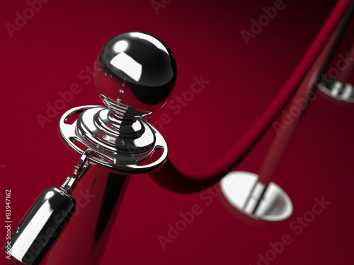 Stainless steel barrier with red rope.