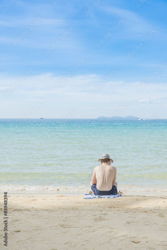 Summer, Travel, Vacation and Holiday concept - Man sitting on be