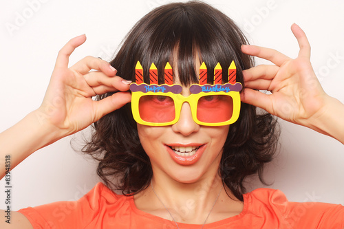 young happy woman with big orange sunglasses