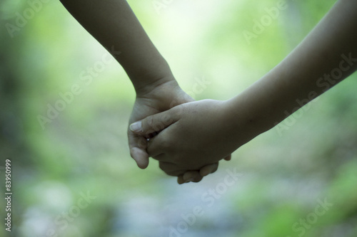 Children holding hands in the park © Monet